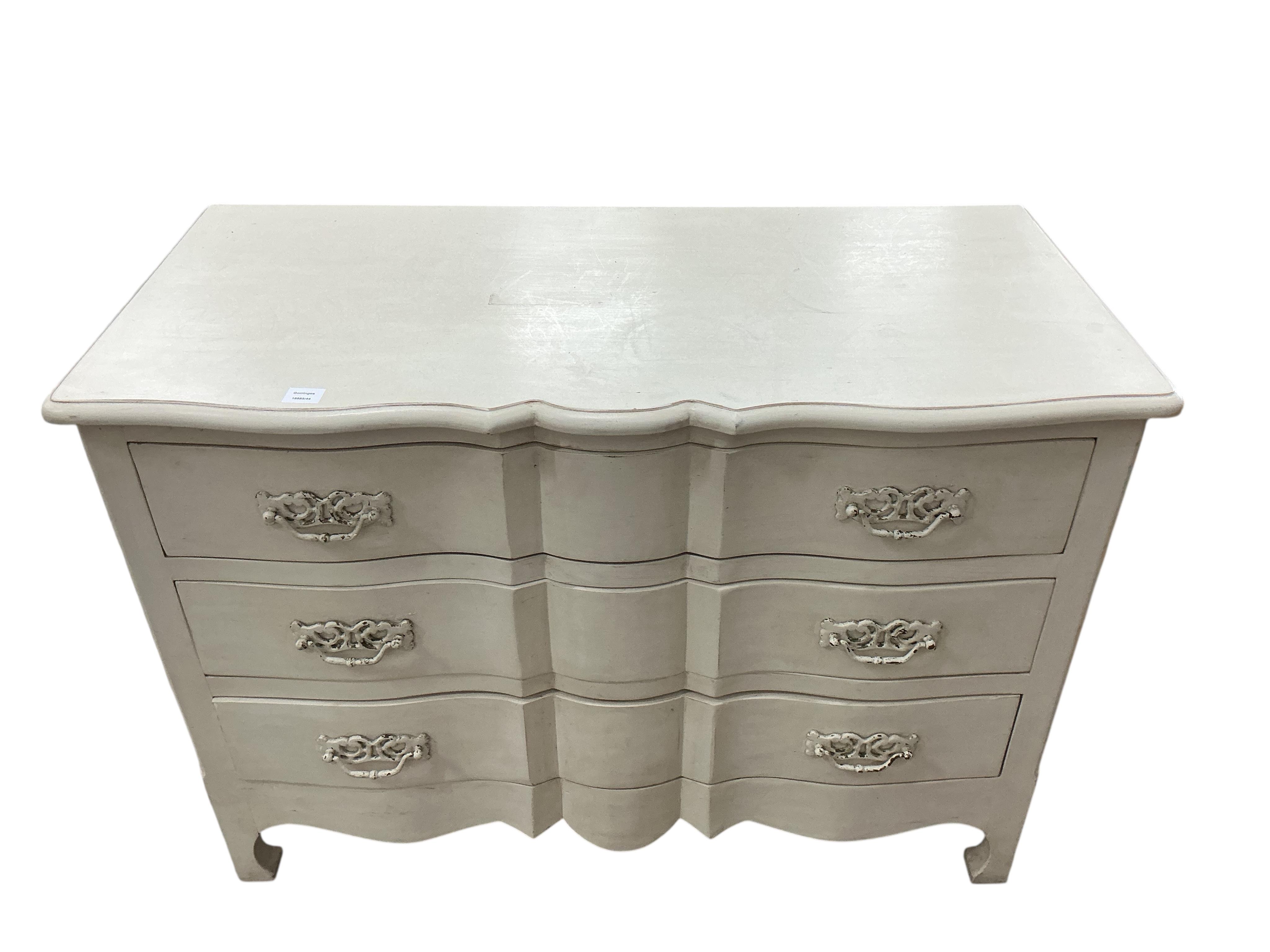 An 18th century style cream painted three drawer commode, width 126cm, depth 61cm, height 90cm, Provenance: The late Kenneth Turner (1936-2025), celebrity florist, designer and perfume retailer, he received the Royal War